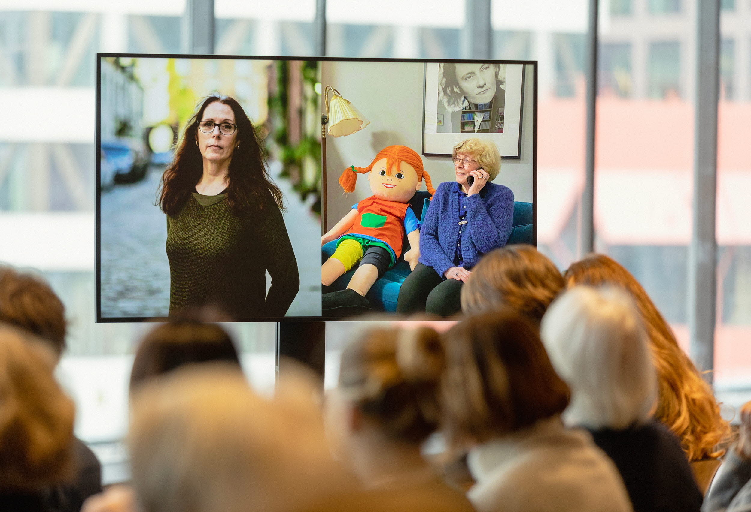 A photo of a TV showing the phone call from Jury chair Boel Westin and the 2023 Laureate Laurie Halse Anderson