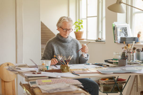 ALMA laureate Eva Lindström at work. Sitting at her desk in a light room.